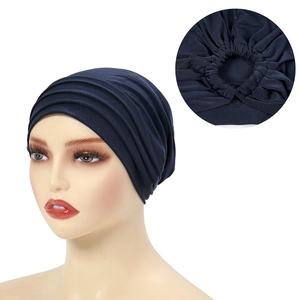 Detail view of the navy blue turban hat showing elastic pleated back on a mannequin