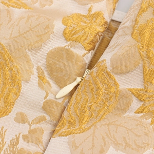 Detailansicht aus gelbem floralem Jacquard-Stoff mit verdecktem Reißverschluss am Oberteil
