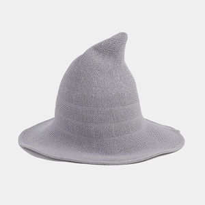 Detailed close-up of light grey knitted wizard hat with a pointed top and wide brim