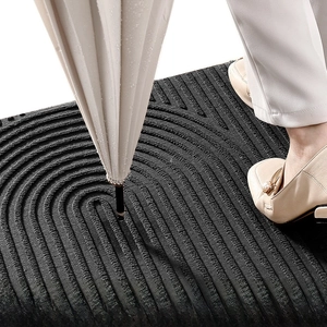 Detail of dark grey U-groove anti-slip door mat texture with moisture-wicking fibers