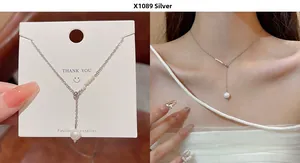 Detail of silver pearl Y-shaped necklace X1089 with delicate chain and drop pendant