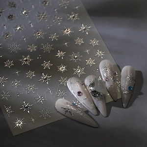 Silver snowflake and star nail art stickers with metallic finish and crystal accents
