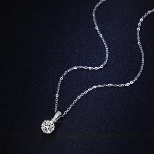 Classic 925 sterling silver necklace with a 1-carat moissanite pendant on blue velvet