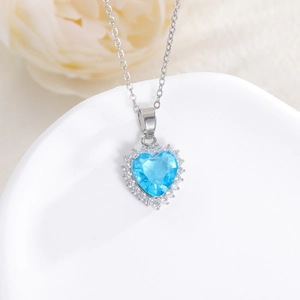 Elegant silver heart necklace with large sky blue gemstone and white zircon border