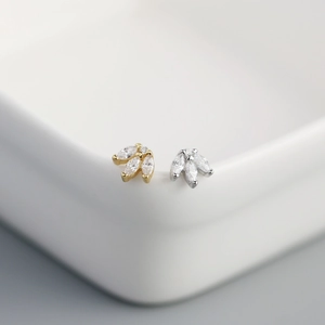 Macro shot of marquise-cut crystal clover studs in gold and silver plating