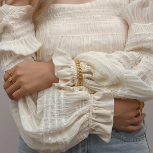 18K gold plated Cuban link bracelet and embossed rings set worn by a female model