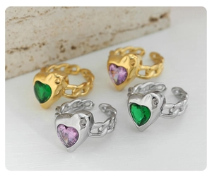 Macro detail of heart-shaped purple and green zircon rings with chain bands