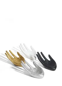 Artistic hand-shaped jewelry display stands with floral relief in gold, silver, black and white