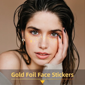 Macro shot of metallic gold heart freckle tattoo stickers on a woman's face