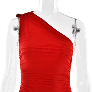Detail view of red one-shoulder dress with elegant ruched fabric and slim fit texture