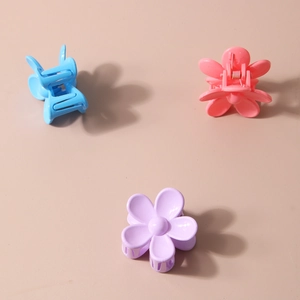 Three matte floral hair claws in blue, pink, and purple colors for women's hair styling