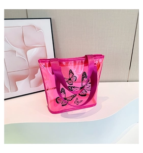 Close-up of pink transparent PVC tote bag with black butterfly print on wavy display stand