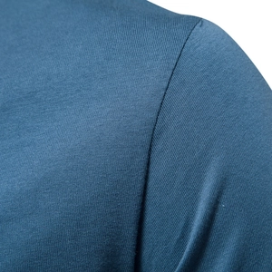 Close-up of shoulder seams on a blue V-neck cotton T-shirt with high-density knit fabric