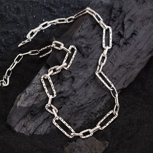 Elegant silver textured rectangular link chain necklace displayed on black charcoal background