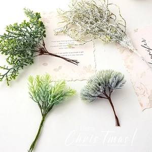 Artificial Christmas greenery branches with faux snow for DIY holiday wreaths and home decor