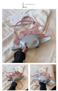 Detail view of silver dinosaur-shaped crossbody bag with pink plates and shoulder strap