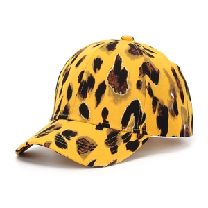 Detail of yellow leopard print baseball cap with glittery texture and classic curved brim