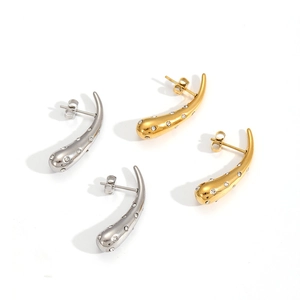 Detail view of gold and silver teardrop earrings featuring sparkling zircon stone inlay