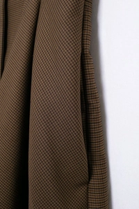 Close-up of retro plaid pattern fabric showing detailed texture of the mini dress