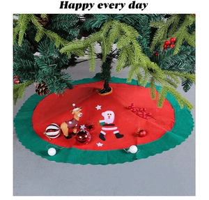 Detail of red felt Christmas tree skirt with Santa Claus, reindeer and wavy green borders