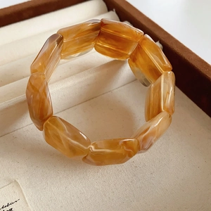 Macro shot of amber resin stretch bracelet with tortoiseshell pattern in a jewelry box