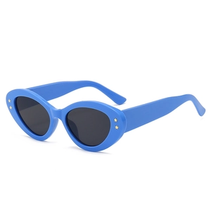 Blue cat eye sunglasses with gold star studs and grey lenses in 45-degree view