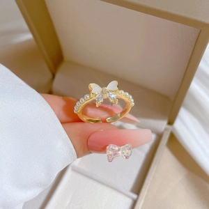 Adjustable gold butterfly ring with white enamel wings, sparkling cubic zirconia and pearls