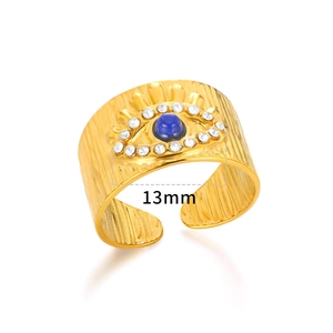 Detail of 18K gold evil eye ring with blue stone and vertical brushed texture, 13mm width