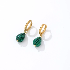 Close-up of golden hoop earrings featuring green teardrop-shaped malachite pendants