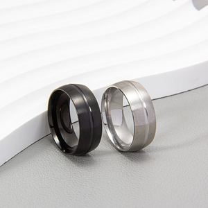 Matte black and silver titanium steel rings with a center groove and brushed finish