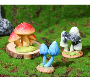 Detailed macro view of 3-piece resin mushroom set with faux moss base on green grass