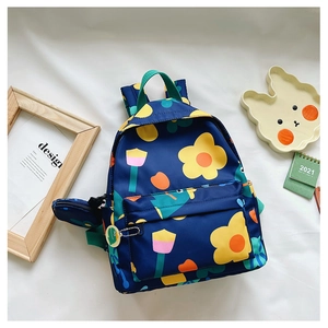 Flat lay of floral kids backpack with green straps and matching small round coin purse