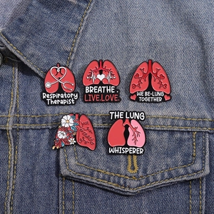 Five-piece medical lung enamel pins on denim jacket featuring respiratory therapist slogans