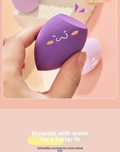 Detail of purple teardrop makeup sponge with cartoon face and dense pores for smooth application