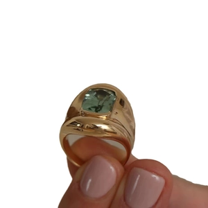 Vintage gold ring featuring a rectangular green tourmaline gemstone on a wide band