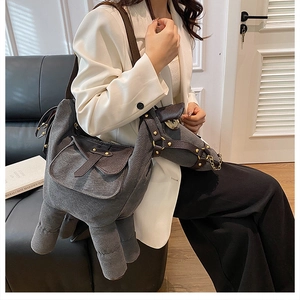 Creative gray animal shaped canvas shoulder bag with metallic rivets shown on model