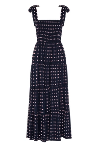 Detail of smocked bodice and adjustable tie straps on a navy pink polka dot tiered maxi dress