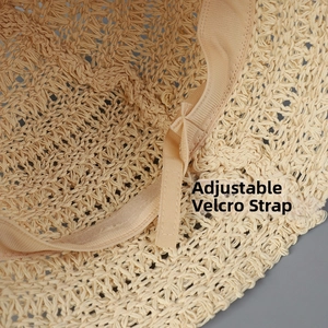 Detail of adjustable velcro strap inside the beige woven bucket hat for custom fit