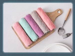 Thick absorbent microfiber cleaning cloths rolled neatly on a wooden kitchen board