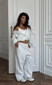 Détail d'un ensemble veste courte à capuche gris clair et pantalon de sport large