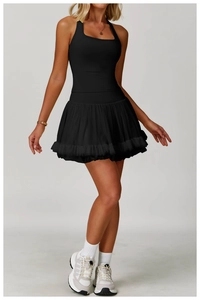 Close-up of black halter neck sports dress with a layered mesh pleated skirt and slim fit
