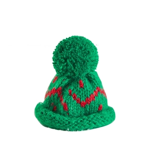 Mini red and green knitted Christmas hat with pompom for holiday tree decoration