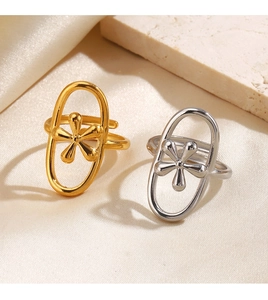 Macro view of geometric cross rings with hollow oval frame and 3D flower detail