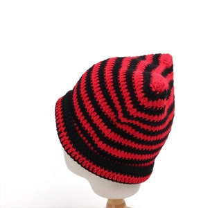 Detailed view of red and black striped knit texture on a winter cat ear beanie hat