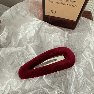 Close-up of wine red velvet BB hair clip with soft texture on white background
