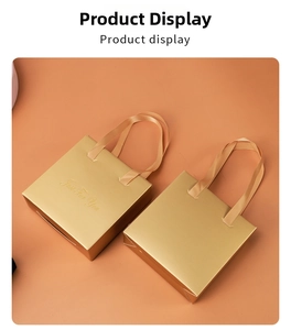 Close-up of matte golden gift bags with satin handles and gold Just For You typography