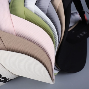 Detailed texture of colorful knitted sun visors with fine ribbed fabric and letter embroidery