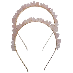 Golden double-layer headband with natural pink crystal stones on a white background