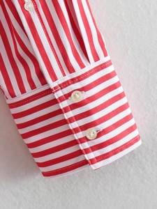 Detail of red and white striped poplin shirt showing button cuffs and fine stitching