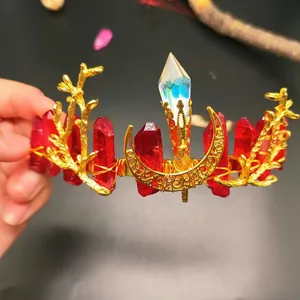 Macro detail of red crystal crown with golden branches and crescent moon element